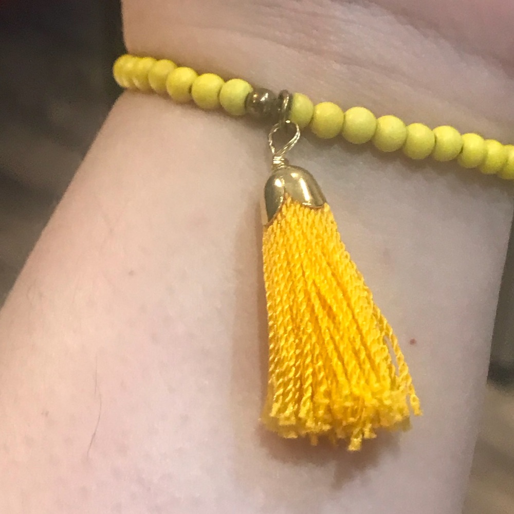 Yellow beaded bracelet with tassel